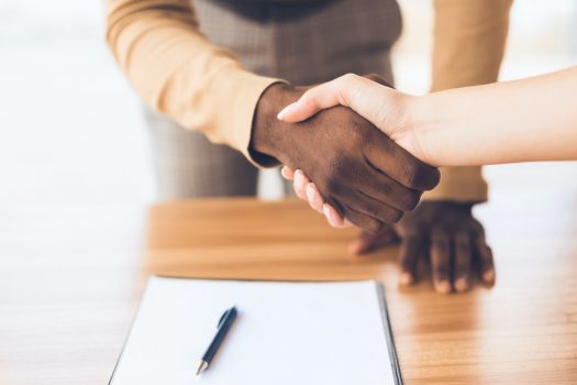 Successful business people shaking hands closing deal